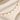 Gold Novelle Necklace spelling AMELIA in letter charms on cream satin