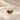 Demi Heart Necklace in gold with January garnet and May emerald pear-cut stones forming a heart