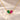 Demi Heart Necklace in gold with May emerald and July ruby pear-cut stones forming a heart