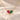 Demi Heart Necklace in gold with July ruby and May emerald pear-cut stones forming a heart
