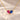 Demi Heart Necklace in gold with July ruby and September sapphire pear-cut stones forming a heart