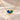 Demi Heart Necklace in gold with September sapphire and May emerald pear-cut stones forming a heart