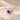 Demi Heart Necklace in gold with September sapphire and October pink tourmaline pear-cut stones forming a heart