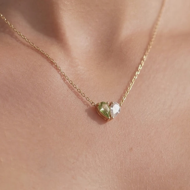 Demi Heart Necklace, Ring and Bracelet in gold with peridot and diamond pear-cut stones, worn at the collarbone, hand and wrist